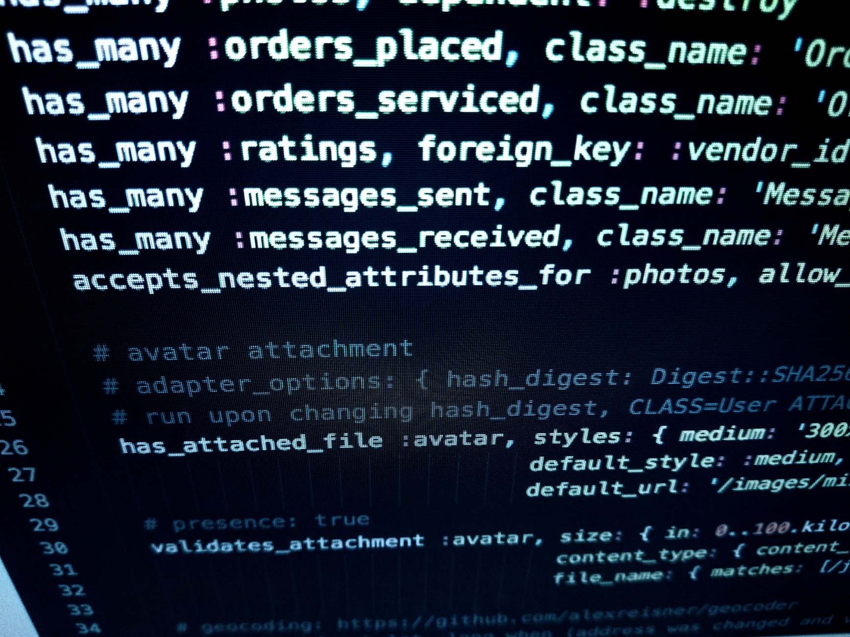Laptop screen showing source code on a desk with detailed programming code on a computer screen
